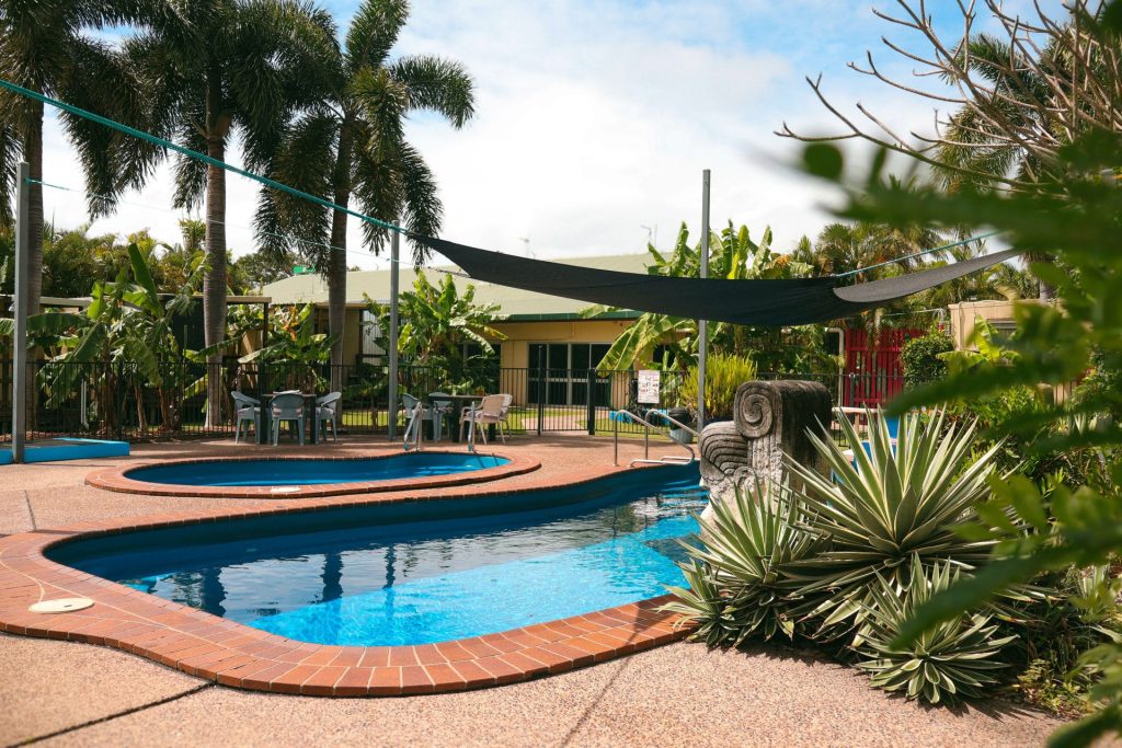A pool surrounded by palms